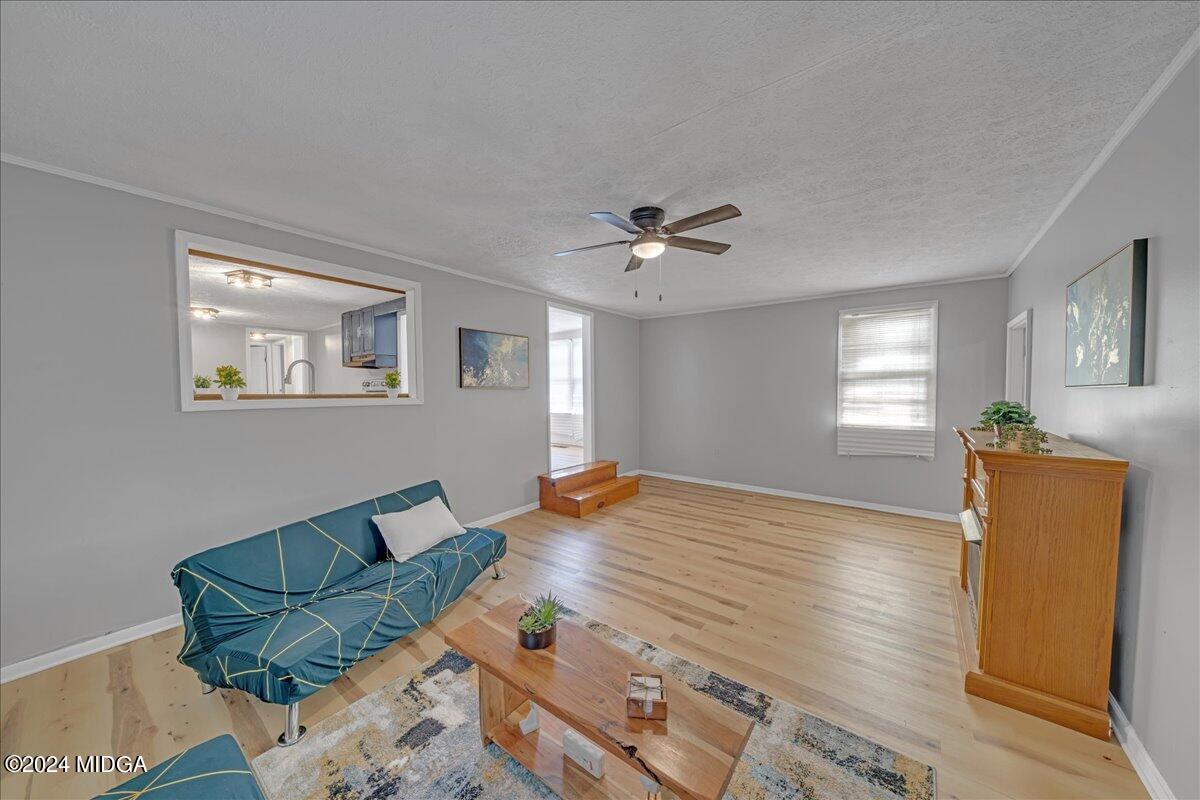 389 Hudson Jones Road Cochran, GA 31014 - Photo 10 of 29 a living room with furniture and a wooden floor