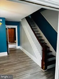 a view of entryway and hall with wooden floor
