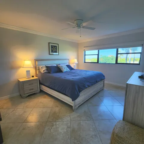 a bathroom with a granite countertop sink a mirror and shower
