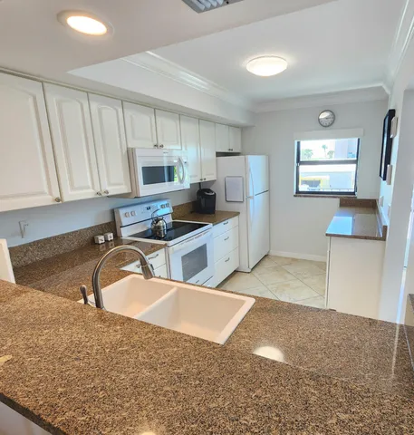 a kitchen with a stove and a window