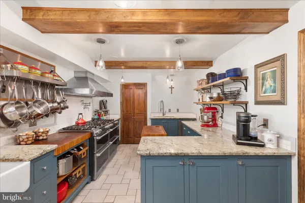 a kitchen with stainless steel appliances granite countertop a sink and cabinets