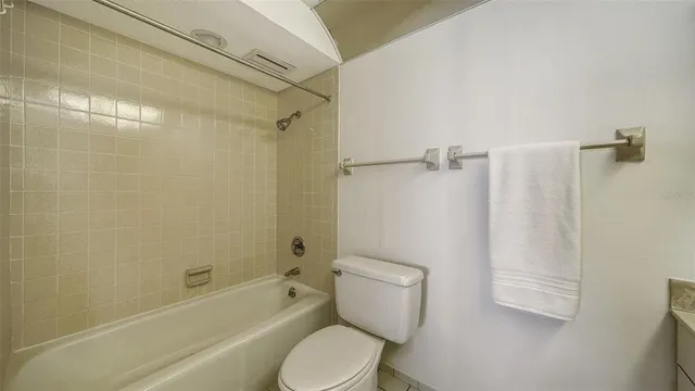 a view of a tennis ground with large trees