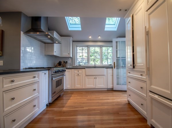 22 Allen Road Winchester, MA 01890 - Photo 5 of 38 a kitchen with granite countertop a stove and a wooden floors