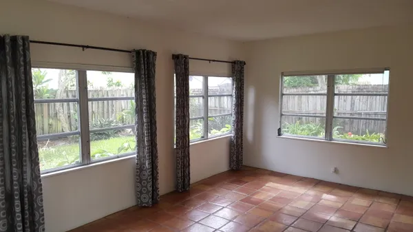 a kitchen with granite countertop a stove a sink and a microwave