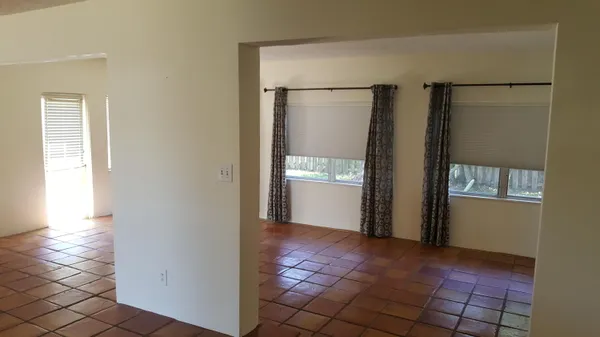 a view of empty room with wooden floor and fireplace