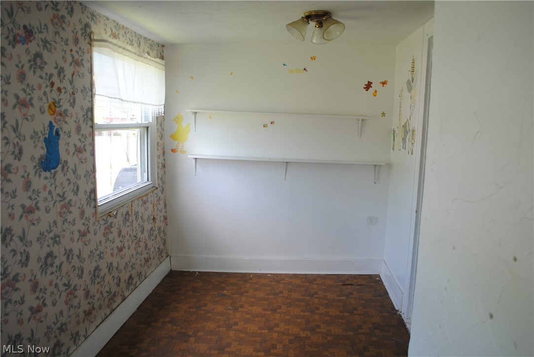 16110 Rockside Road Maple Heights, OH 44137 - Photo 11 of 17 Room with a window, wood-finish flooring, built-in shelving, and a ceiling-mounted light fixture