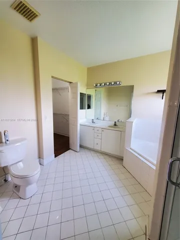 a bathroom with a sink a toilet and mirror