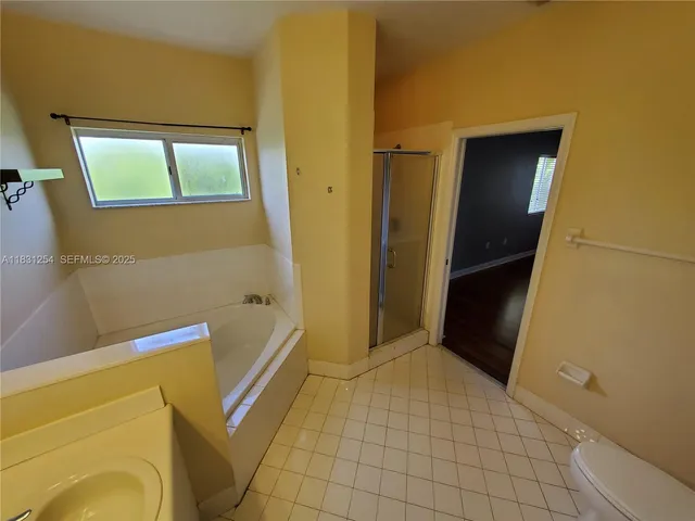 a bathroom with a tub and toilet