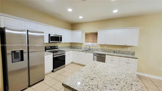 a kitchen with a refrigerator sink and microwave