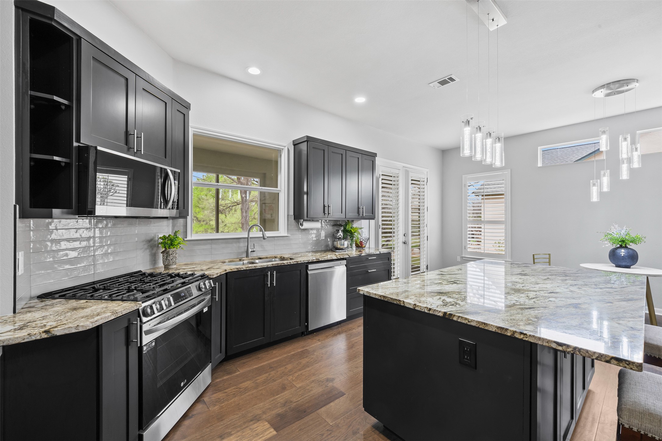 144 Stetson Trail Georgetown, TX 78633 - Photo 12 of 39 a kitchen with stainless steel appliances granite countertop a sink stove and refrigerator