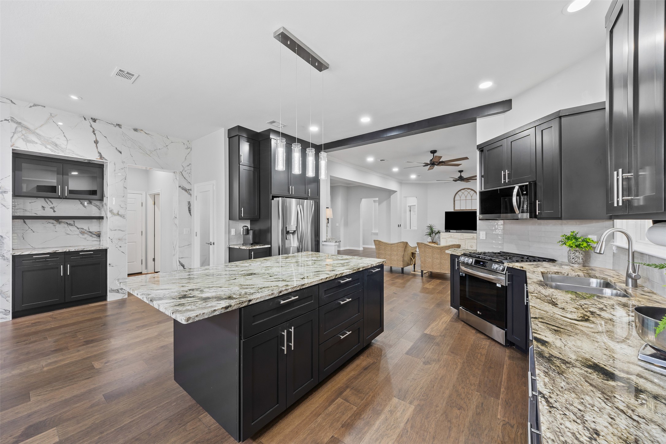144 Stetson Trail Georgetown, TX 78633 - Photo 14 of 39 a large kitchen with stainless steel appliances granite countertop a stove refrigerator and cabinets