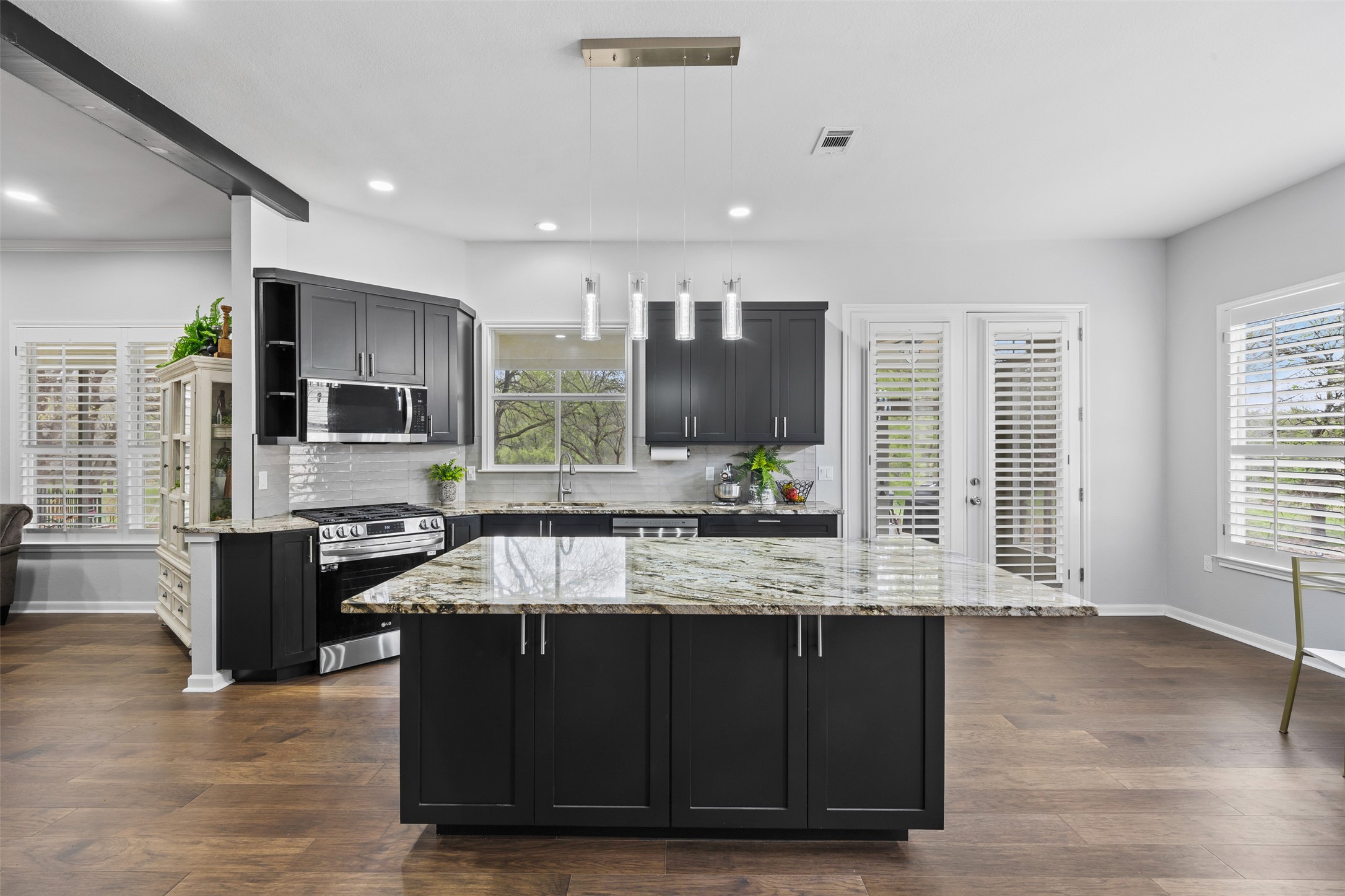 144 Stetson Trail Georgetown, TX 78633 - Photo 17 of 39 a large kitchen with granite countertop a stove and cabinets