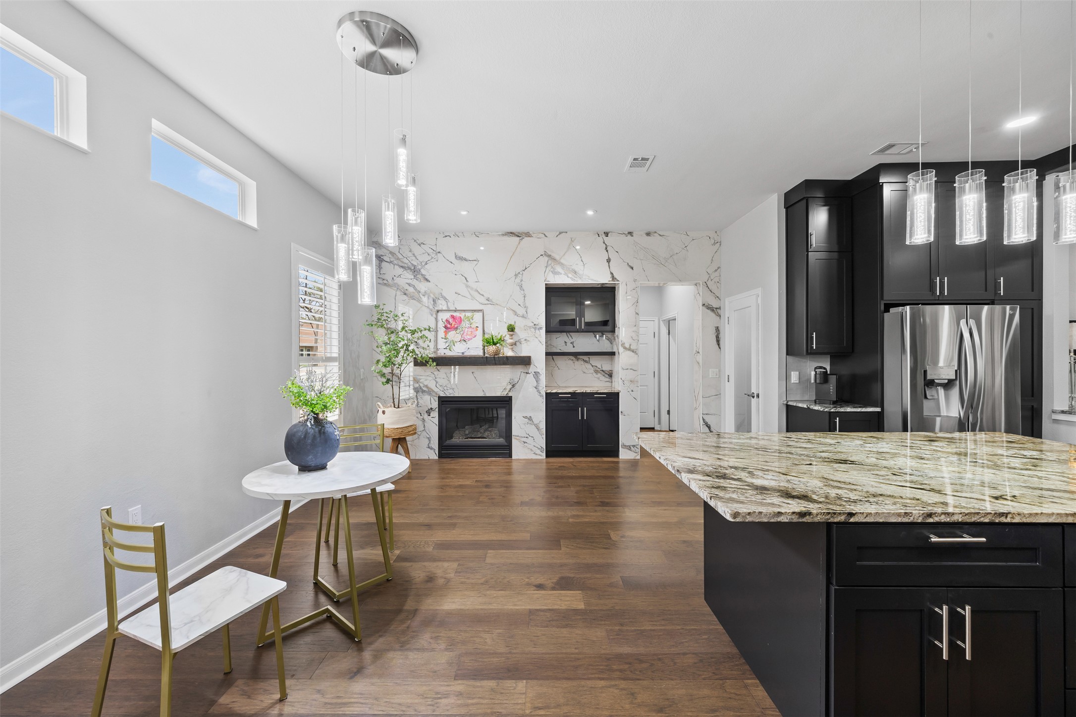 144 Stetson Trail Georgetown, TX 78633 - Photo 2 of 39 a kitchen with stainless steel appliances granite countertop a kitchen island hardwood floor sink stove dining table and chairs