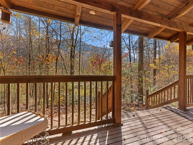 a roof deck with couches and wooden floor