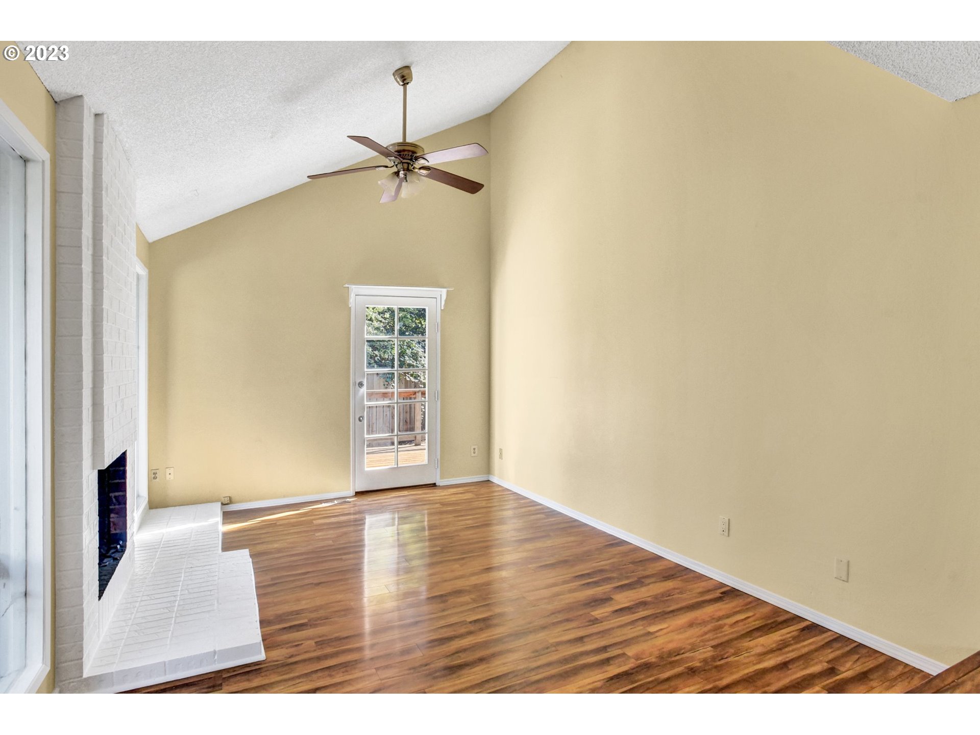 6160 Southwest Heights Lane Beaverton, OR 97007 - Photo 6 of 40 a view of an empty room with wooden floor and a window