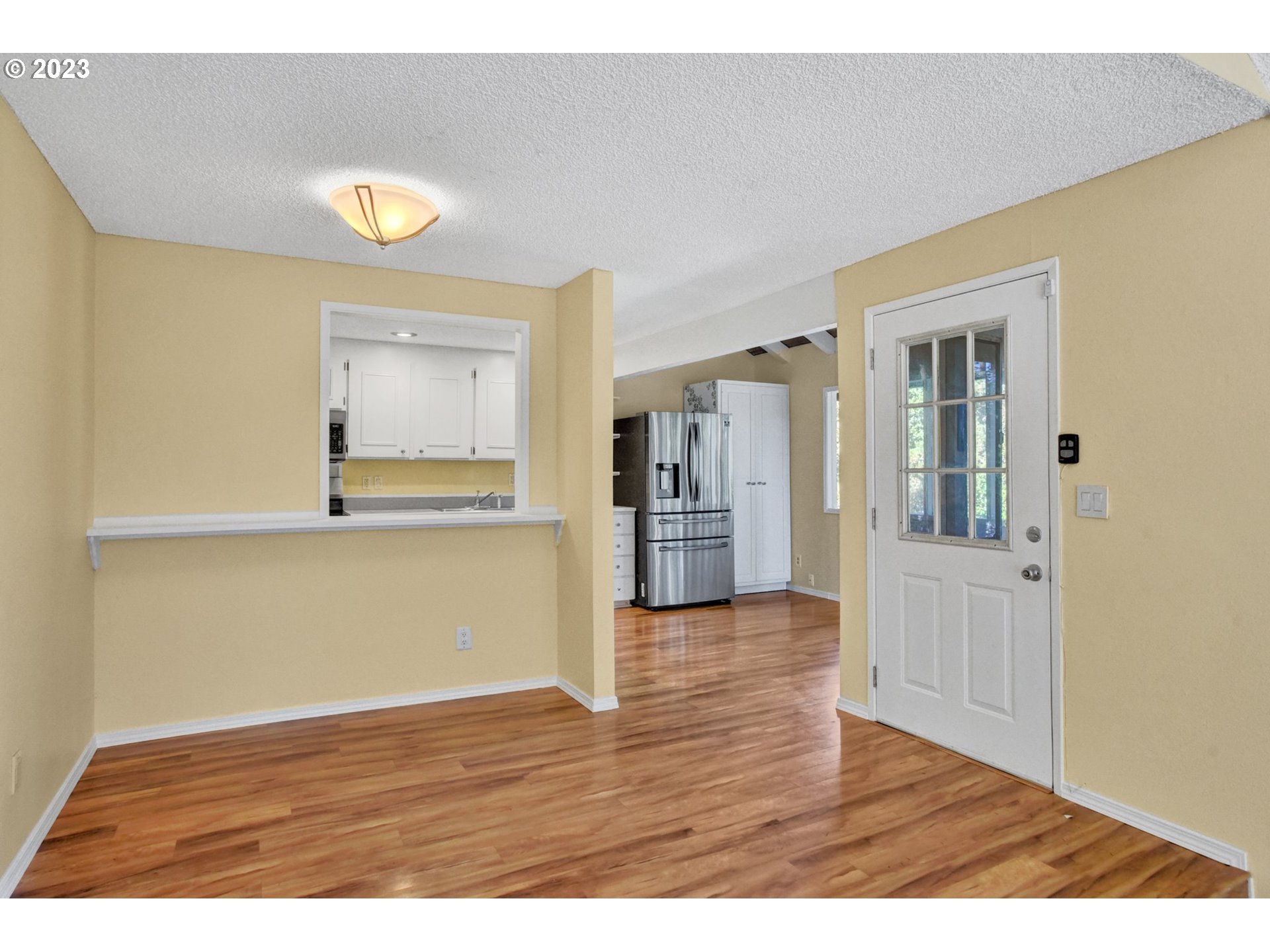 6160 Southwest Heights Lane Beaverton, OR 97007 - Photo 10 of 40 a view of an empty room with wooden floor and a window