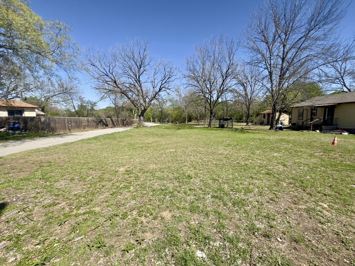 600 Sabine Street Lockhart, TX 78644 - Photo 16 of 19 a tall house with a yard and trees