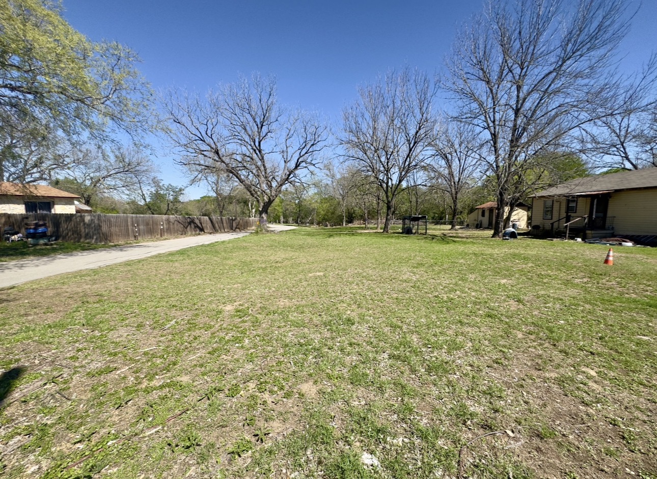 600 Sabine Street Lockhart, TX 78644 - Photo 17 of 19 a view of a yard with a house and a large tree