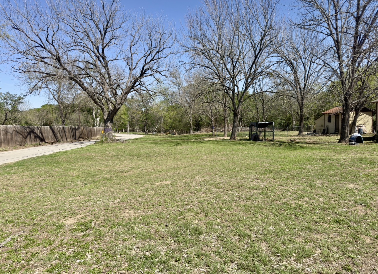 600 Sabine Street Lockhart, TX 78644 - Photo 18 of 19 a view of a field with large trees