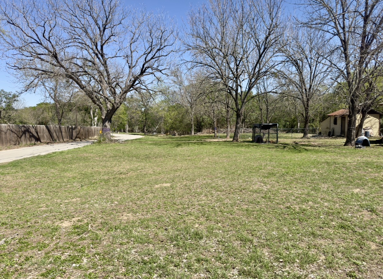 600 Sabine Street Lockhart, TX 78644 - Photo 19 of 19 a view of a field with large trees