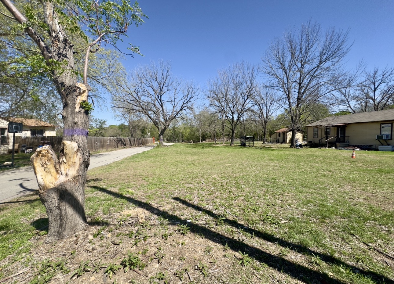 600 Sabine Street Lockhart, TX 78644 - Photo 3 of 19 a view of a backyard with wooden fence