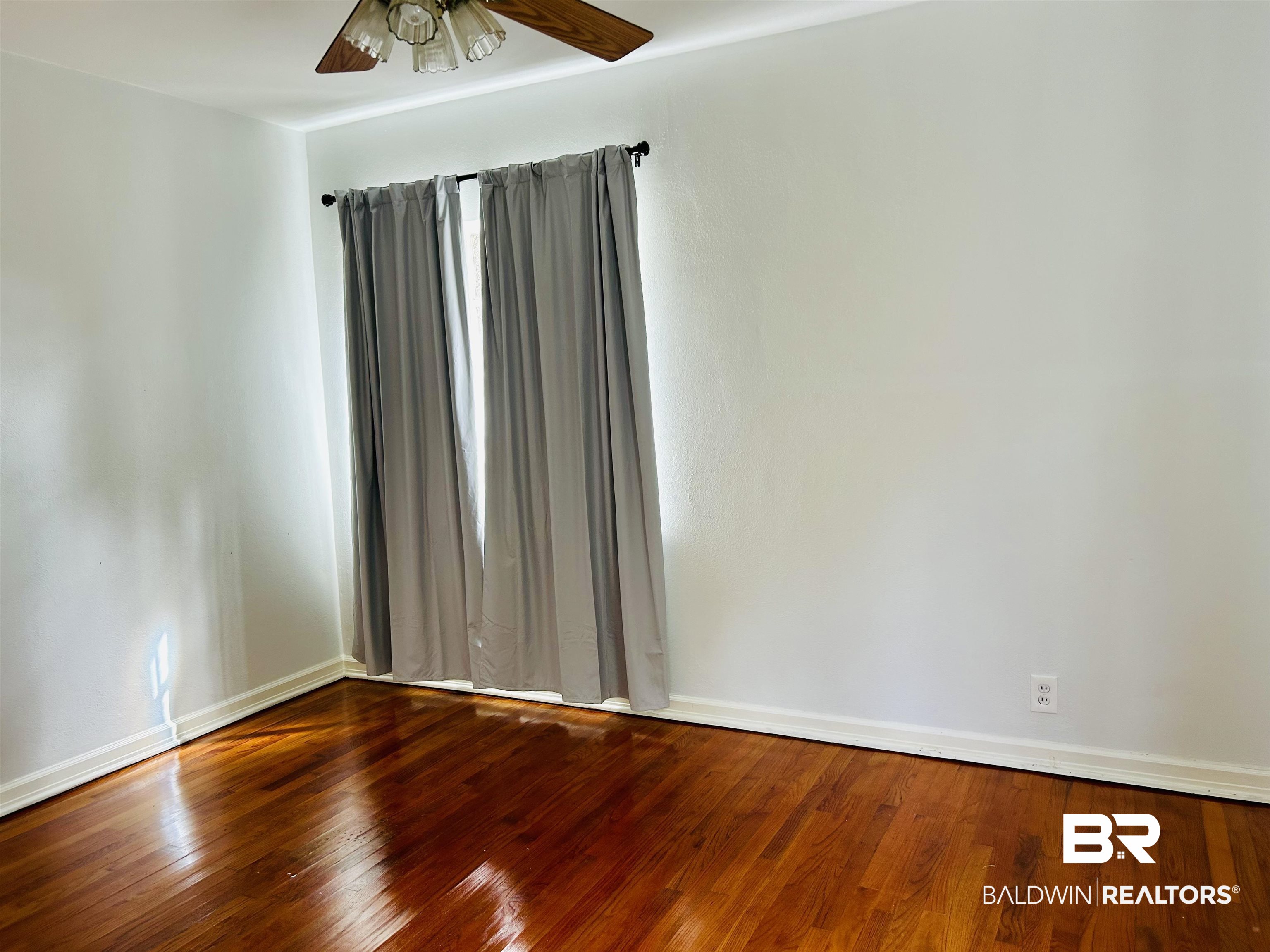 94 Diamond Street Mobile, AL 36611 - Photo 3 of 30 Empty room featuring hardwood / wood-style floors and ceiling fan