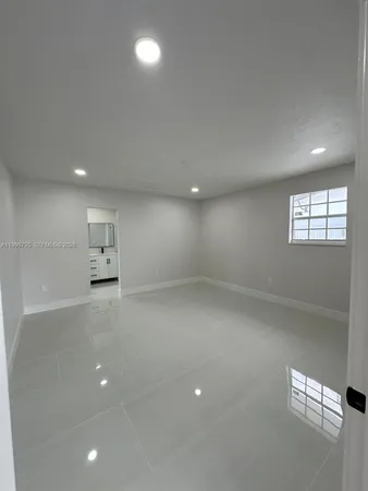 an empty room with windows and closet