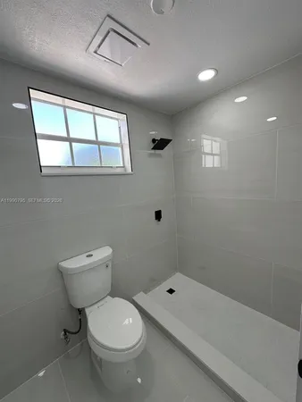 a bathroom with a toilet a sink and a shower