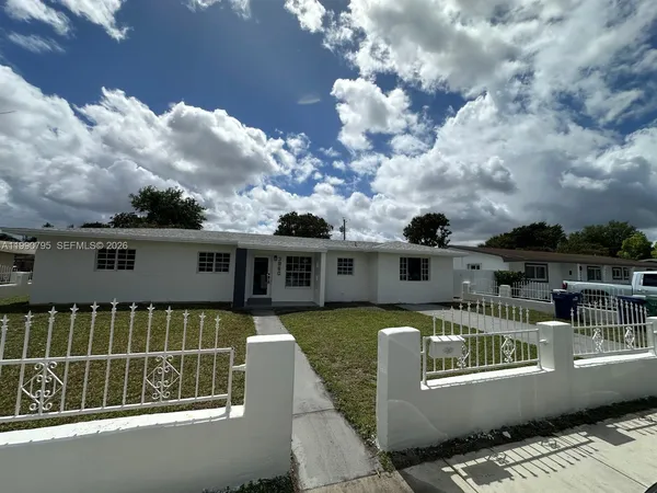 a front view of a house with swimming pool having outdoor seating