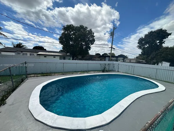 a view of a swimming pool with a yard