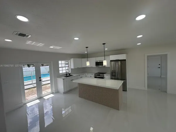 a kitchen with refrigerator and window