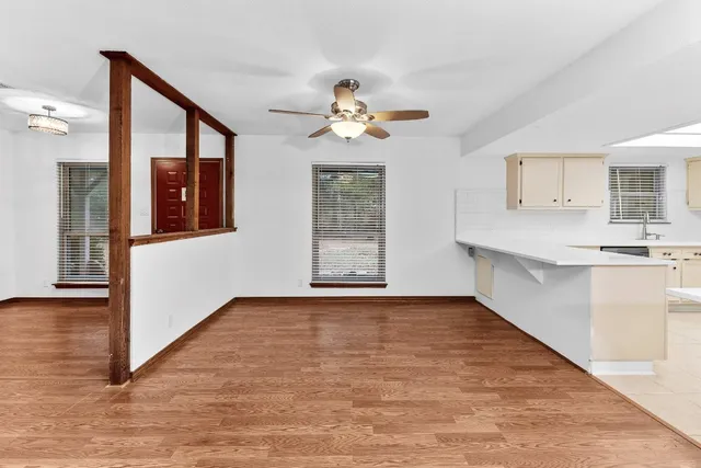 a view of a kitchen with a dishwasher cabinets and wooden floor