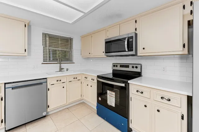 a kitchen with a refrigerator stove and microwave