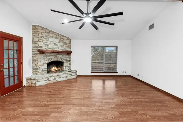 a view of a livingroom with furniture wooden floor and floor to ceiling window