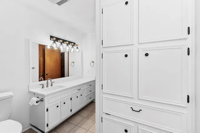 a spacious bathroom with a double vanity sink mirror and toilet