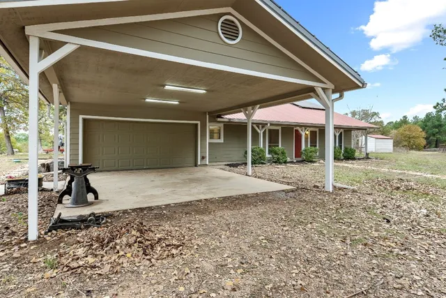 a backyard of a house with a large tree