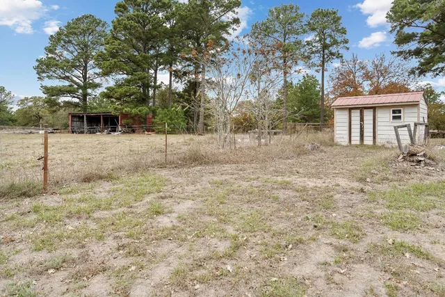 a view of a yard with a house in the background