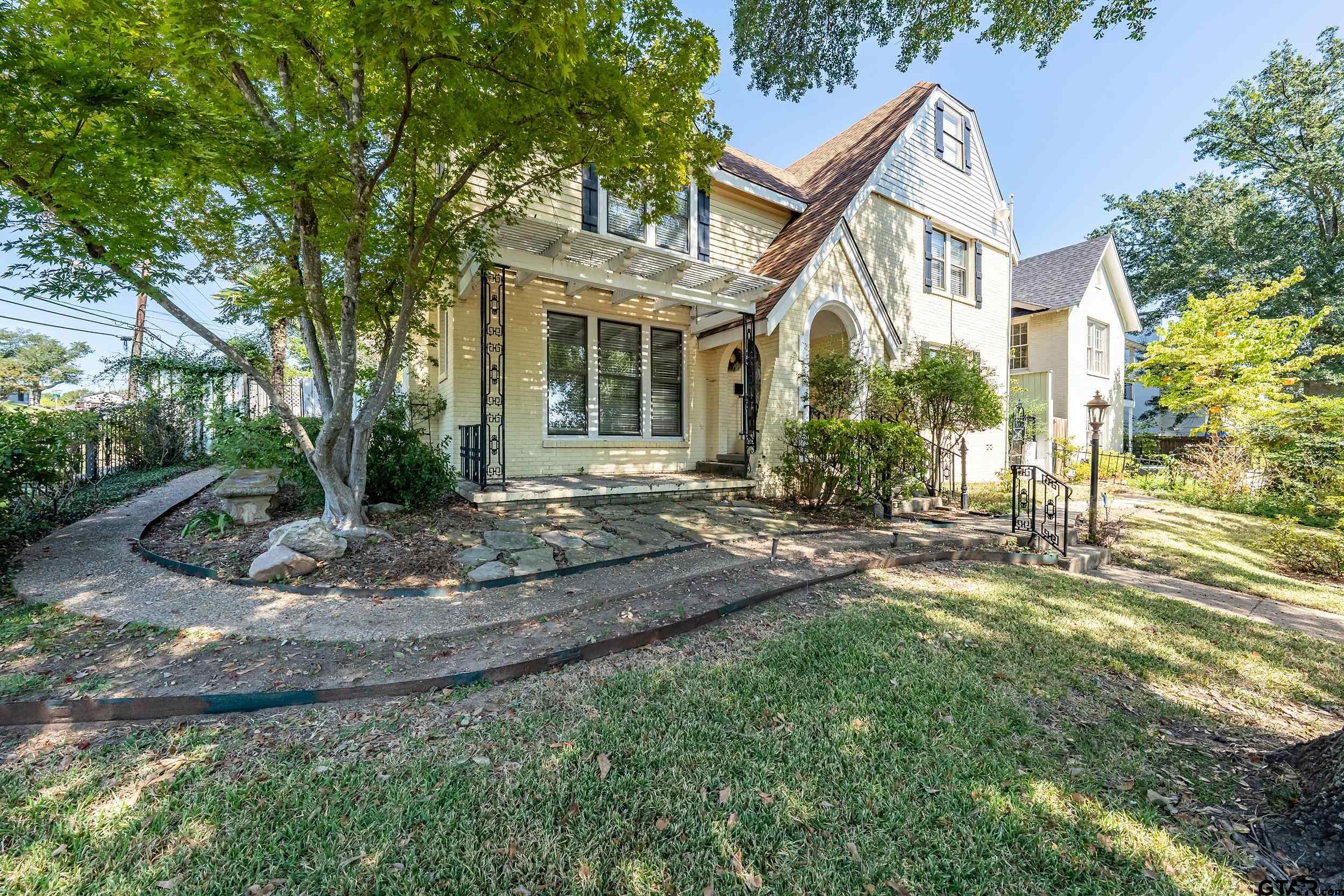 145 Rowland Place Tyler, TX 75701 - Photo 9 of 43 a view of a white house next to a yard with big trees
