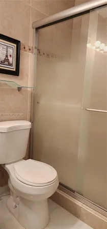 a white toilet sitting next to a bathroom sink