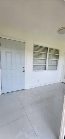 an empty room with an empty space and window