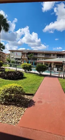 a view of a big yard with potted plants