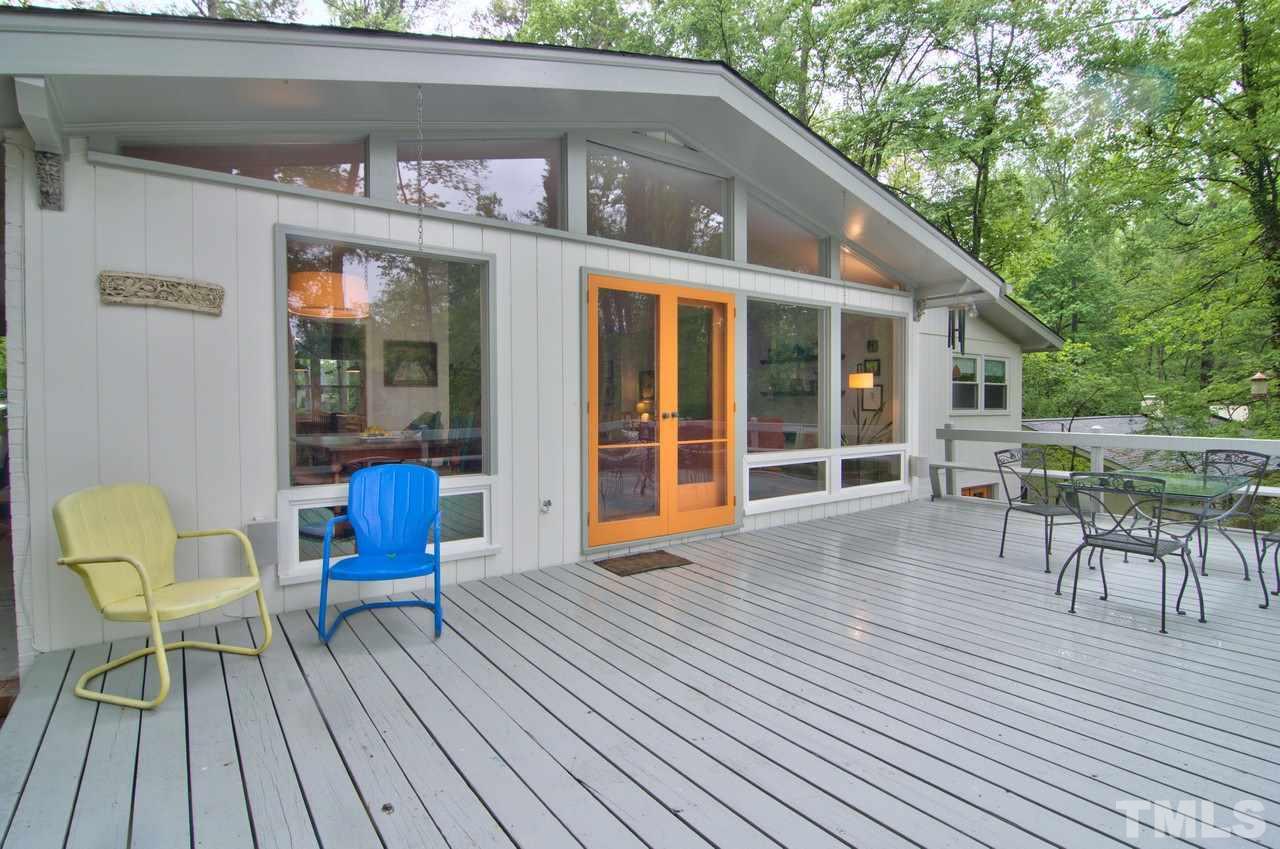 a view of a house with a chairs and table in a patio