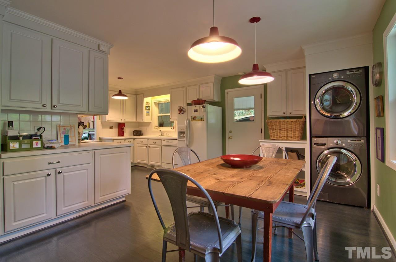 3105 Buckingham Road Durham, NC 27707 - Photo 12 of 25 a kitchen with a table chairs sink and cabinets