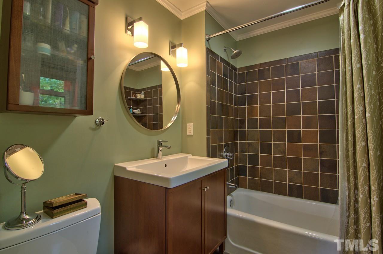 3105 Buckingham Road Durham, NC 27707 - Photo 16 of 25 a bathroom with a sink mirror toilet and bathtub