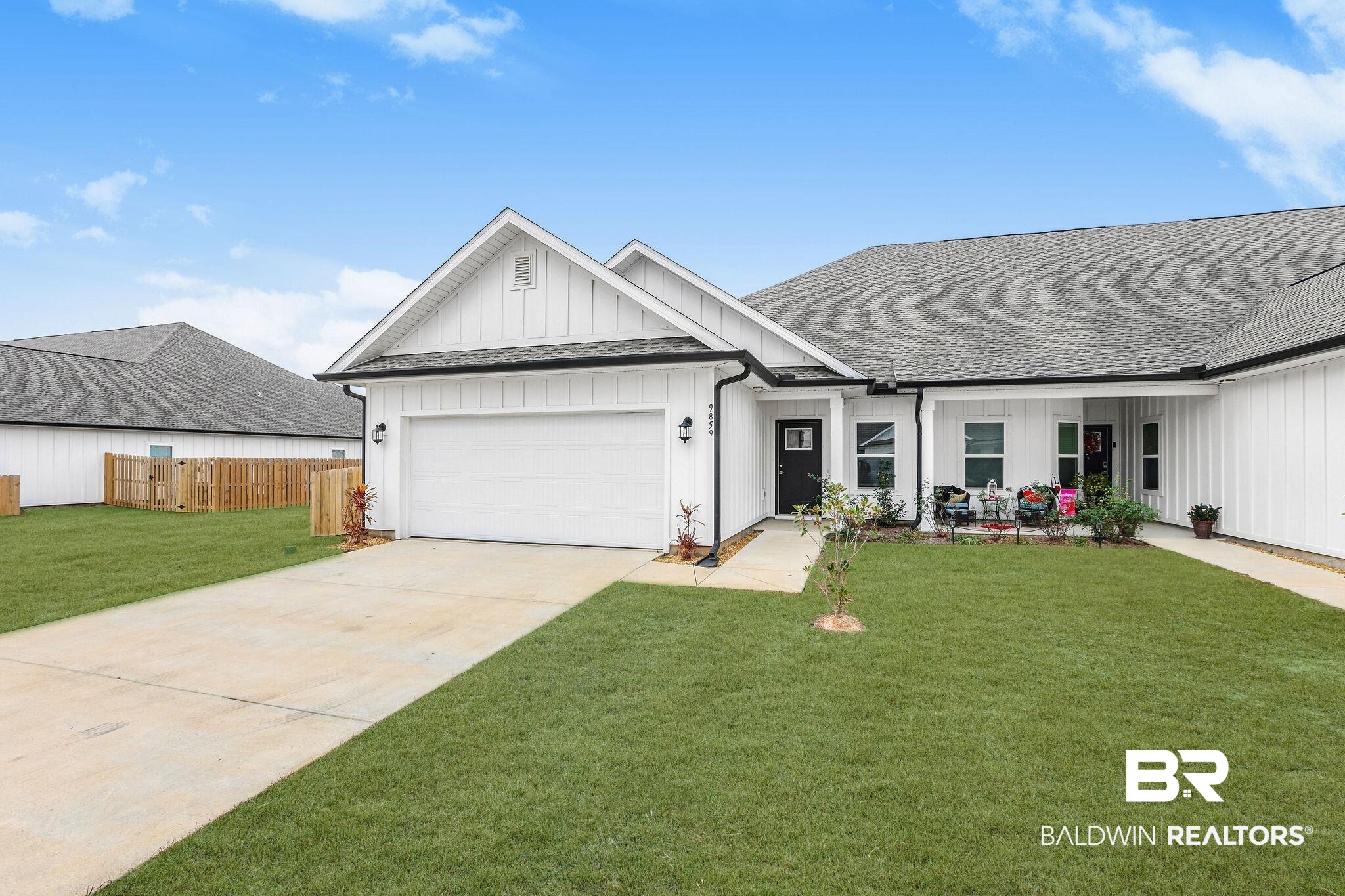 9859 Willet Way Foley, AL 36535 - Photo 1 of 23 Modern farmhouse style home featuring board and batten siding, roof with shingles, concrete driveway, a garage, and covered porch