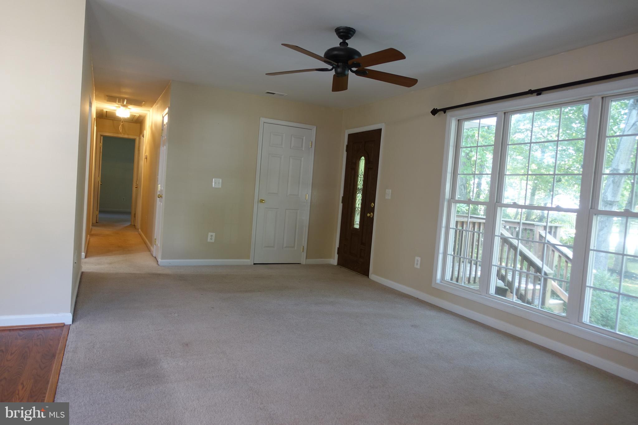 702 Old Love Point Road Stevensville, MD 21666 - Photo 11 of 41 Family room has plenty of light and ceiling fan