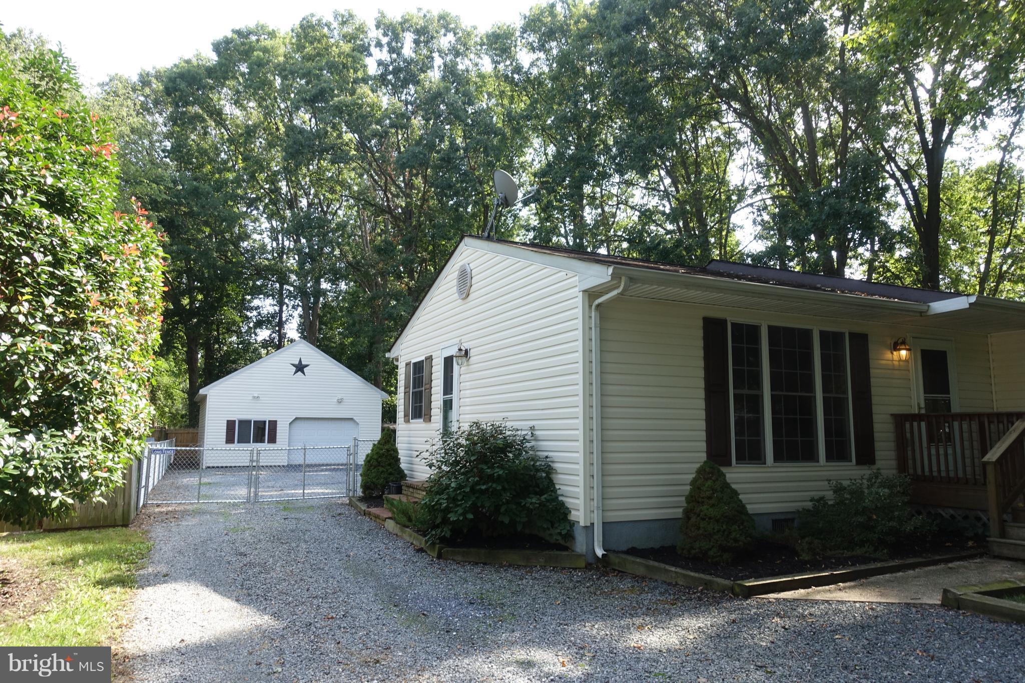 702 Old Love Point Road Stevensville, MD 21666 - Photo 38 of 41 Exterior - driveway extends into fenced back yard