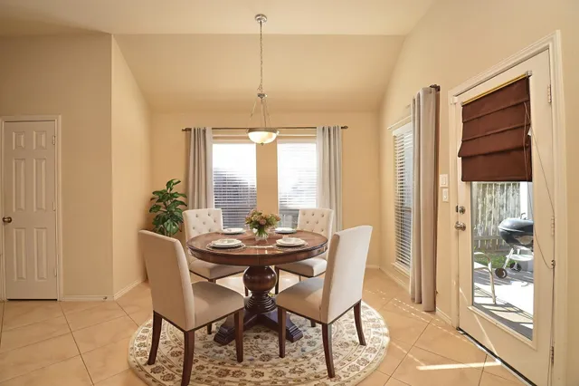 a dining room with furniture and window