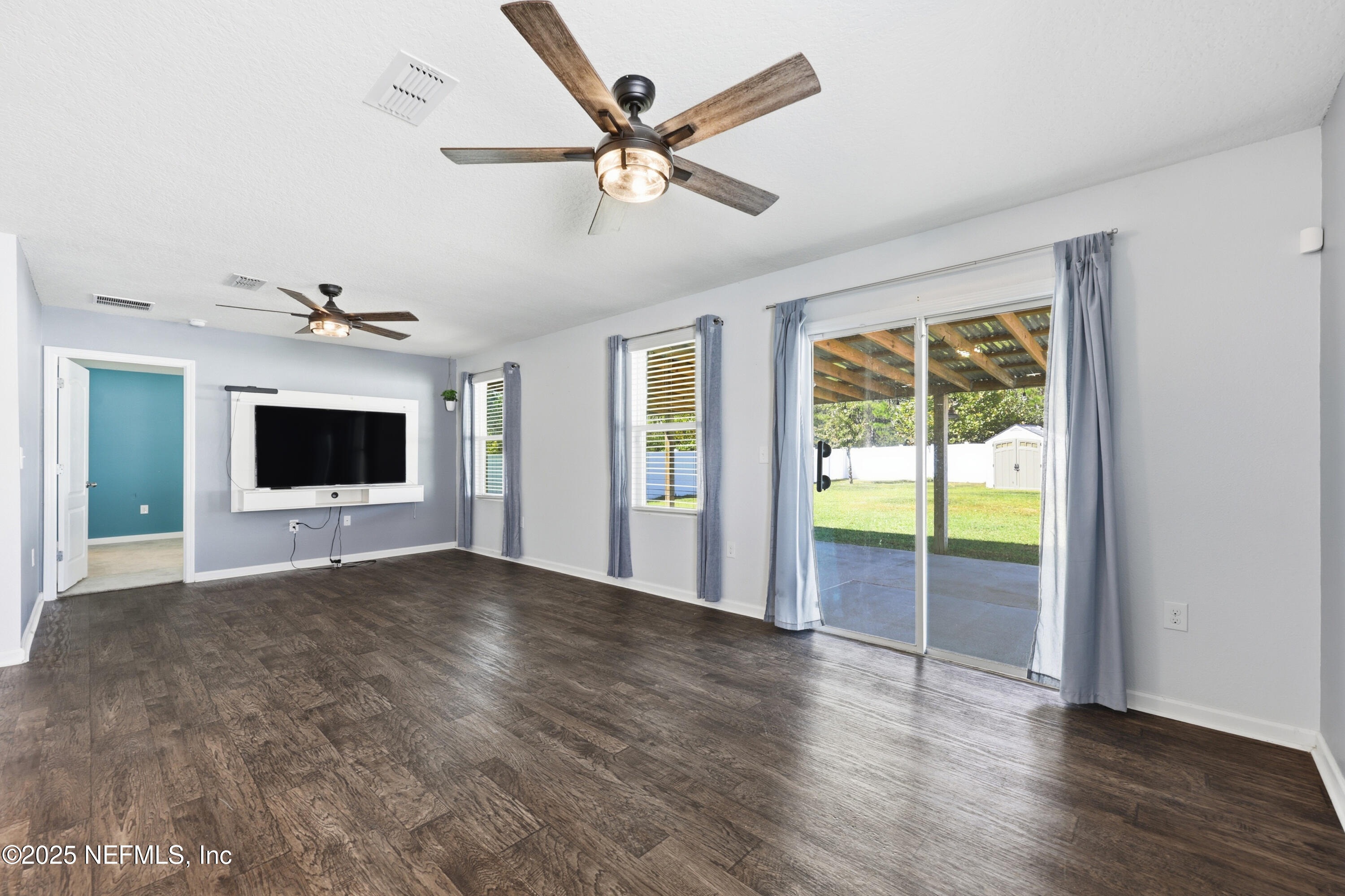 4298 Warm Springs Way Middleburg, FL 32068 - Photo 20 of 36 an empty room with ceiling fan and windows