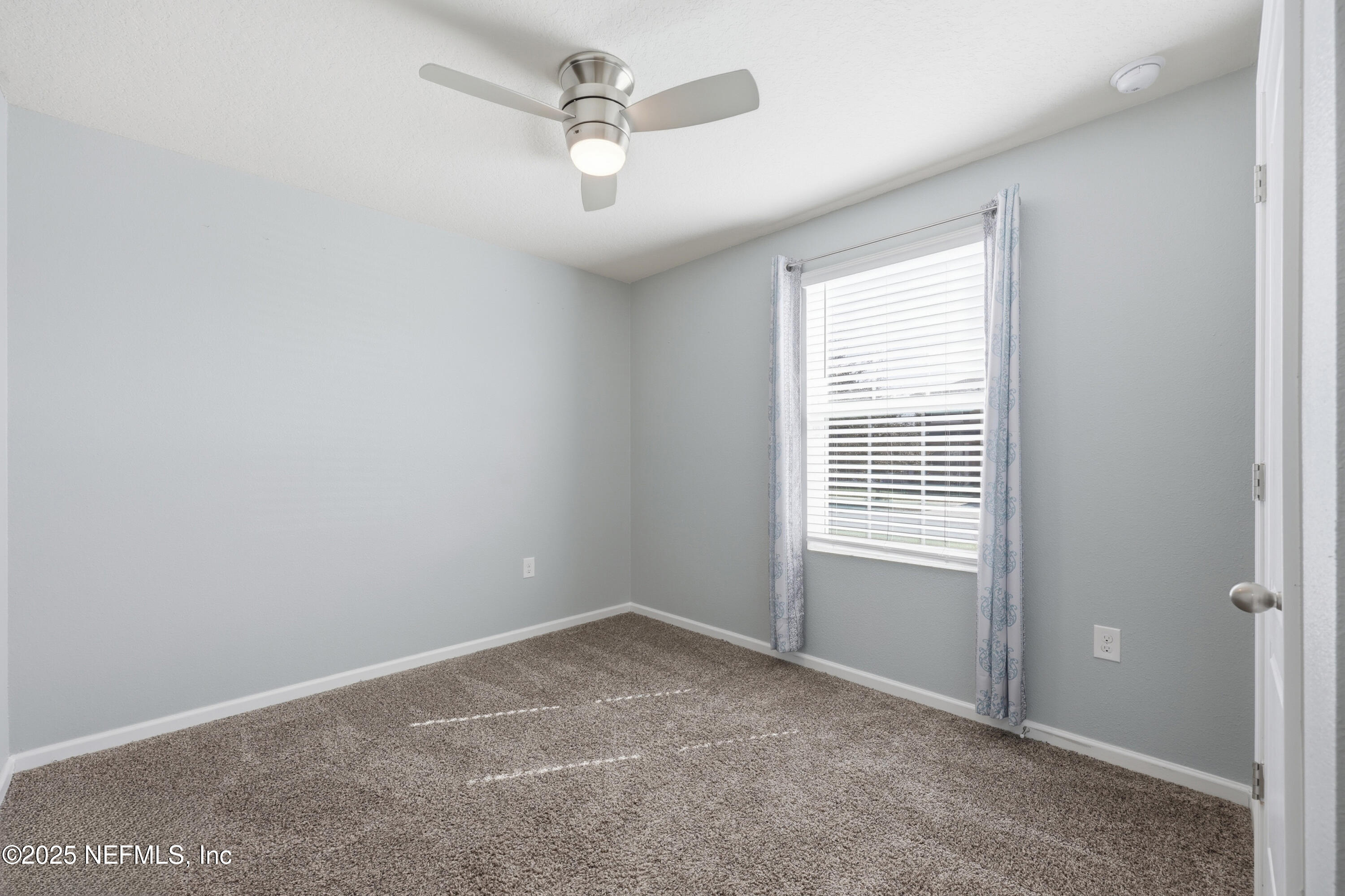 4298 Warm Springs Way Middleburg, FL 32068 - Photo 6 of 36 an empty room with a window